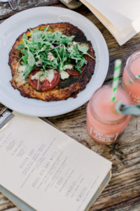 photo of a healthy dish and smoothies on a rough hewn wood table