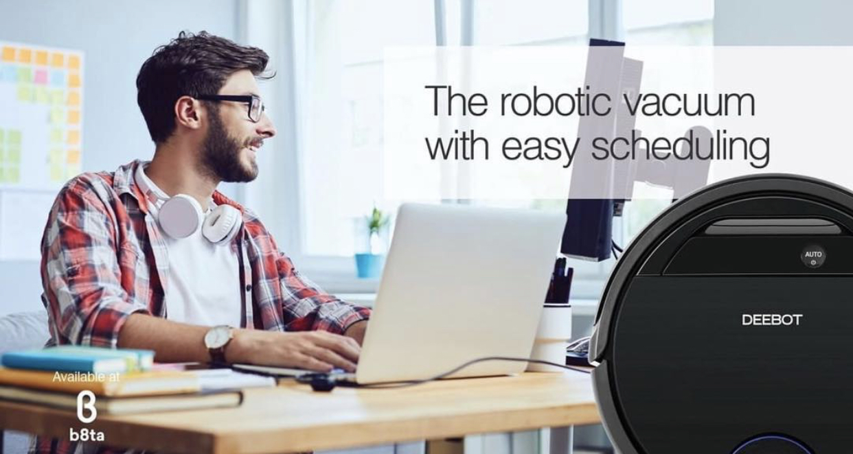 Smiling man at laptop with overlay of robotic vacuum