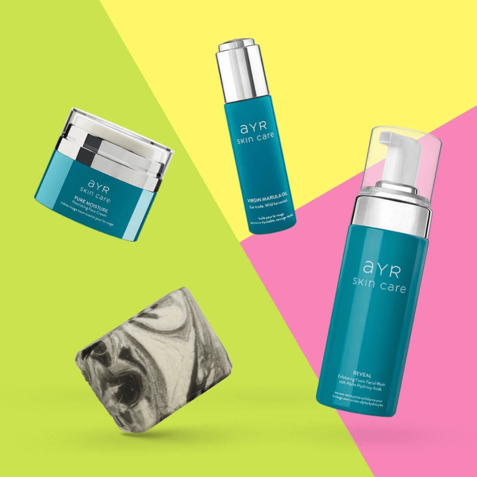 Bottles of different skincare products with a colorful, geometric background