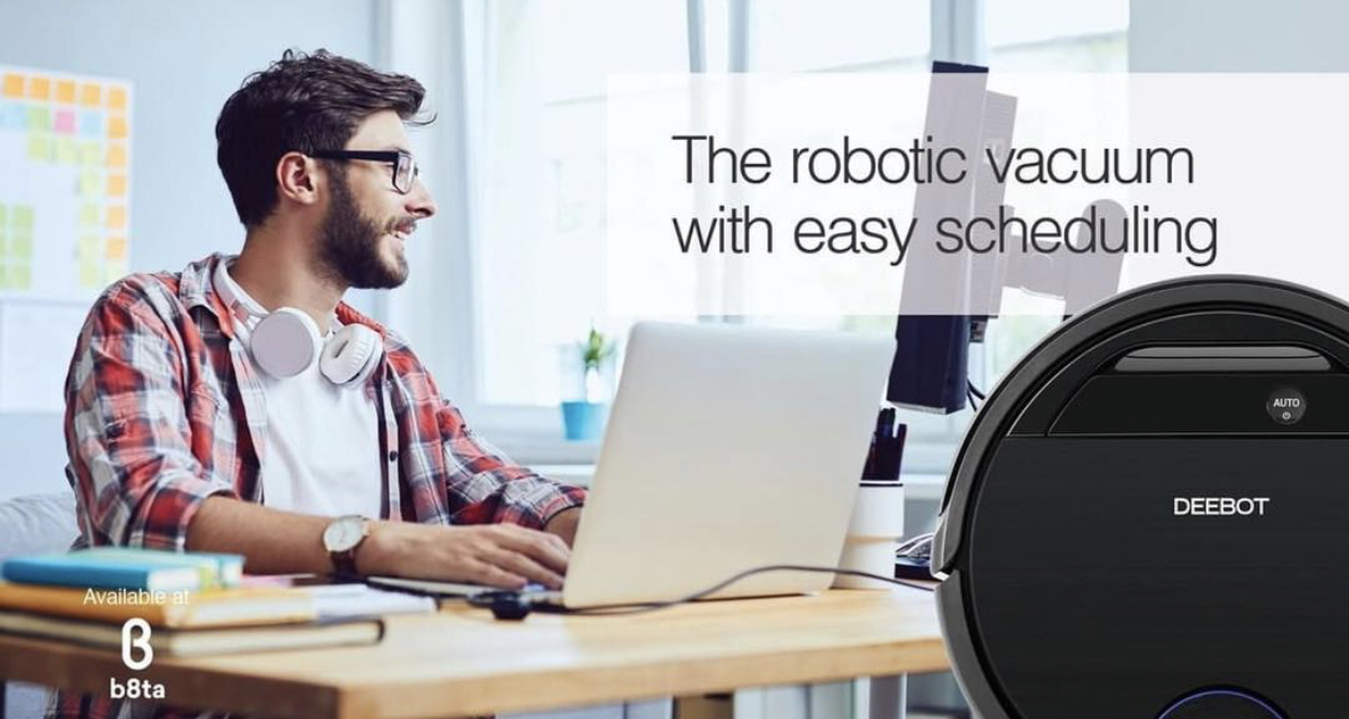 Display of robot vacuum Smiling man at laptop with overlay of robotic vacuum