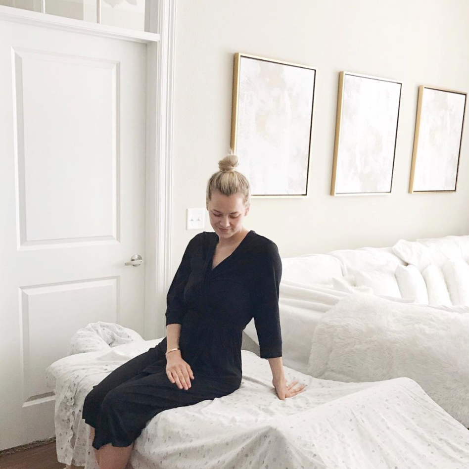 Woman sitting on massage table Woman smiling and sitting on massage table set up in her living room